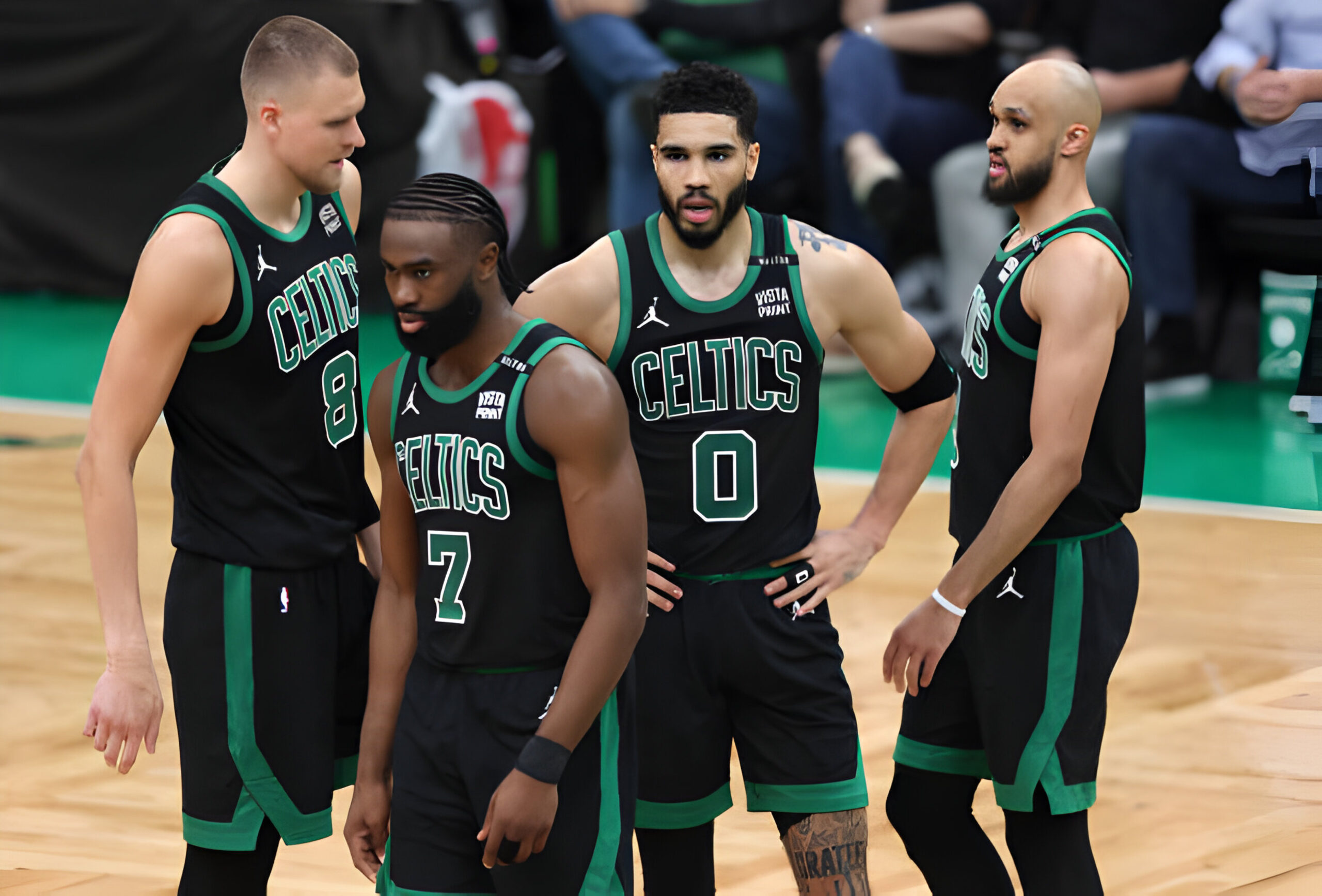 (L to R) Kristaps Porzingis #8, Jaylen Brown #7, Jayson Tatum #0, and Derrick White #9 of the Boston Celtics look on during the second quarter against the Dallas Mavericks in Game Two of the 2024 NBA Finals at TD Garden on June 09, 2024 in Boston, Massachusetts.